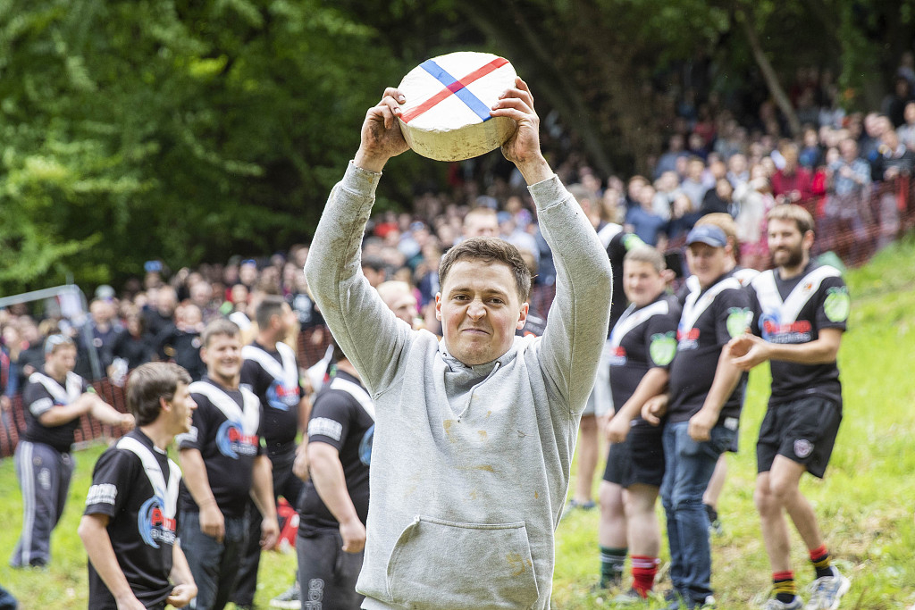 "throw yourself off the top": daredevils enter cheese-rolling