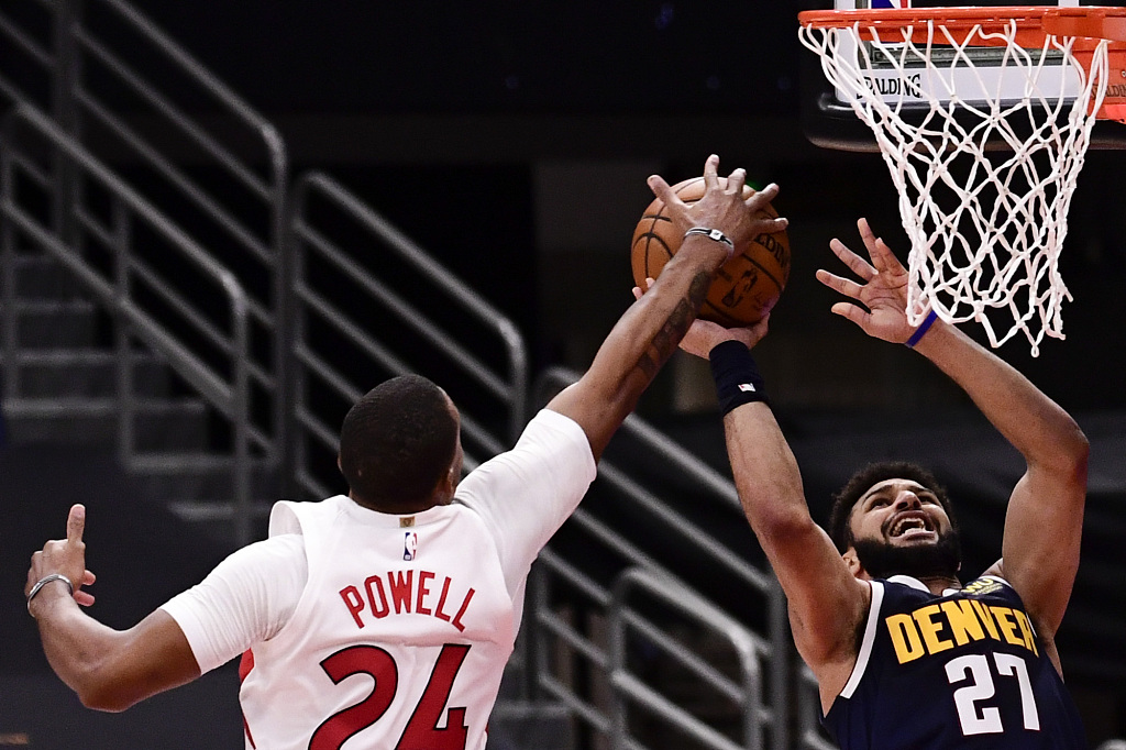 Toronto Raptors forward Norman Powell (24) blocks a shot by Denver Nuggets  guard Jamal Murray (27) during the first half of an NBA basketball game  Wednesday, March 24, 2021, in Tampa, Fla. (