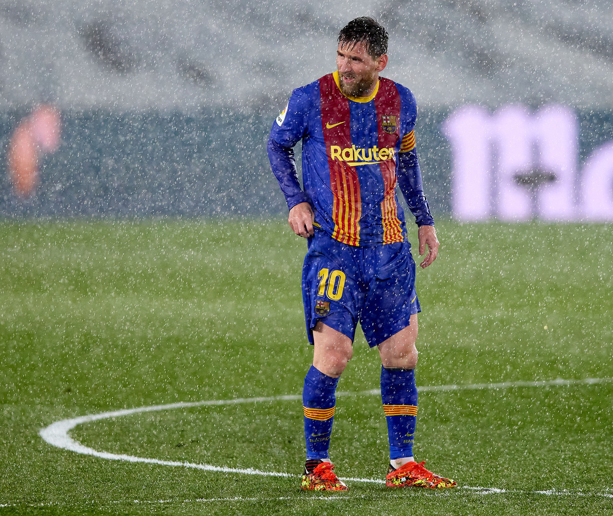 A sogged Lionel Messi is shivering on the pitch as torrential rain disrupts...