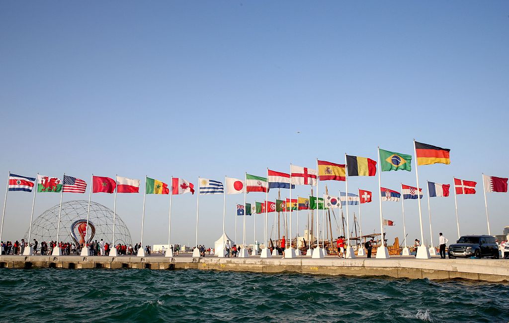 Flags of the 32 qualified teams for the World Cup are raised in the Qatari capital Doha, June 16, 2022. /CFP