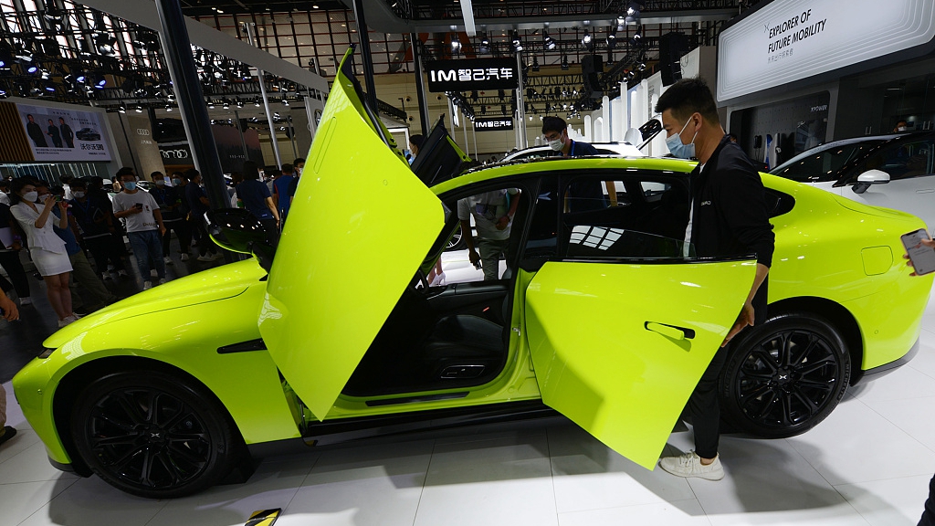 A customer enters an electric vehicle at the Dahe International Auto Show in central China's Henan Province, September 16, 2022. /CFP
