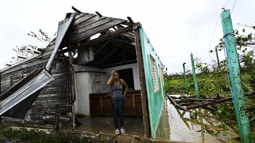 Tobacco company worker Caridad Alvarez stands in her house destroyed by Hurricane Ian in Pinar del Rio Province, Cuba, September 27, 2022. /CFP