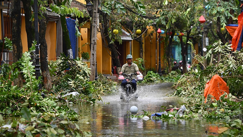 A man rides a motorbike in a flooded street following the passage of typhoon Noru in Hoi An city, Quang Nam province, Vietnam, September 28, 2022. /CFP