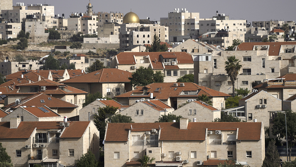 The East Jerusalem Israeli settlement of Pisgat Ze'ev, seen with a neighboring Palestinian neighborhood, May 12, 2022. /CFP