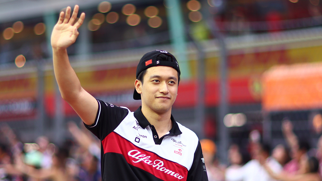 Chinese racer Zhou Guanyu of Alfa Romeo waves to the crowd on the drivers parade prior to the race at Marina Bay Street Circuit in Singapore, October 2, 2022. /CFP 