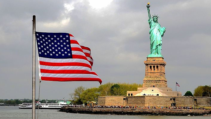 The flag of the U.S. and the Statue of Liberty. /CFP