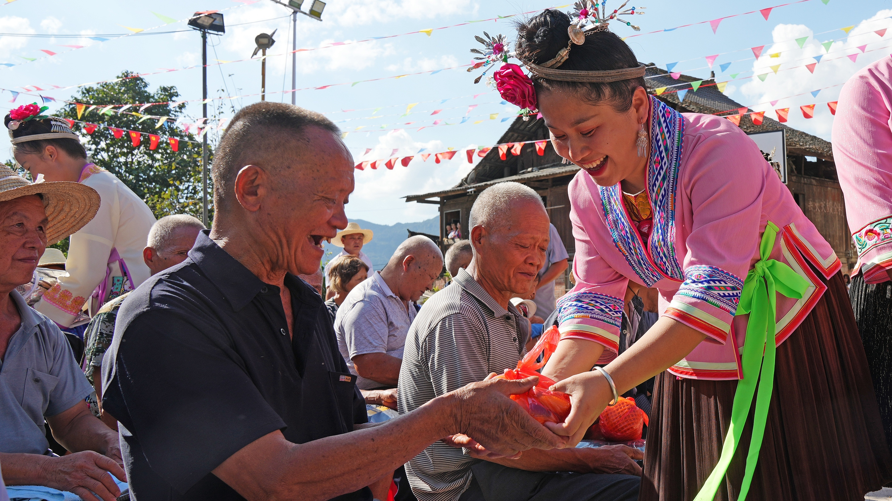 Young people hand out gifts for the elderly at Longcen Village, Rongshui Miao Autonomous County in Liuzhou, Guangxi Zhuang Autonomous Region, China, to welcome the Double Ninth Festival, October 3, 2022. /CFP 