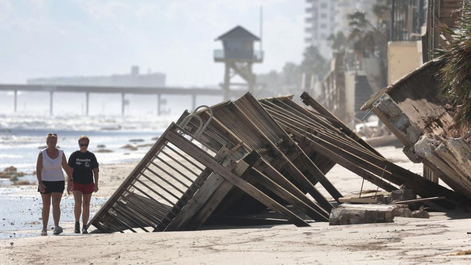 Beachgoers survey the damage in Daytona Beach Shores, Florida, U.S.on October 3, 2022. /AP