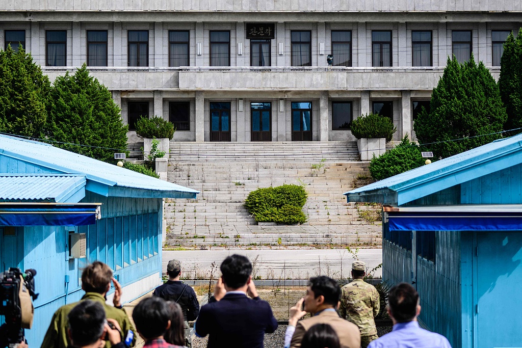 Members of the media (foreground) take photos at the Joint Security Area of the Demilitarized Zone (DMZ) in the truce village of Panmunjom, October 4, 2022. /CFP