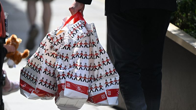 A shopper carries purchases in Hamley's toy shop-branded carrier bags in London, UK, May 12, 2022. /CFP