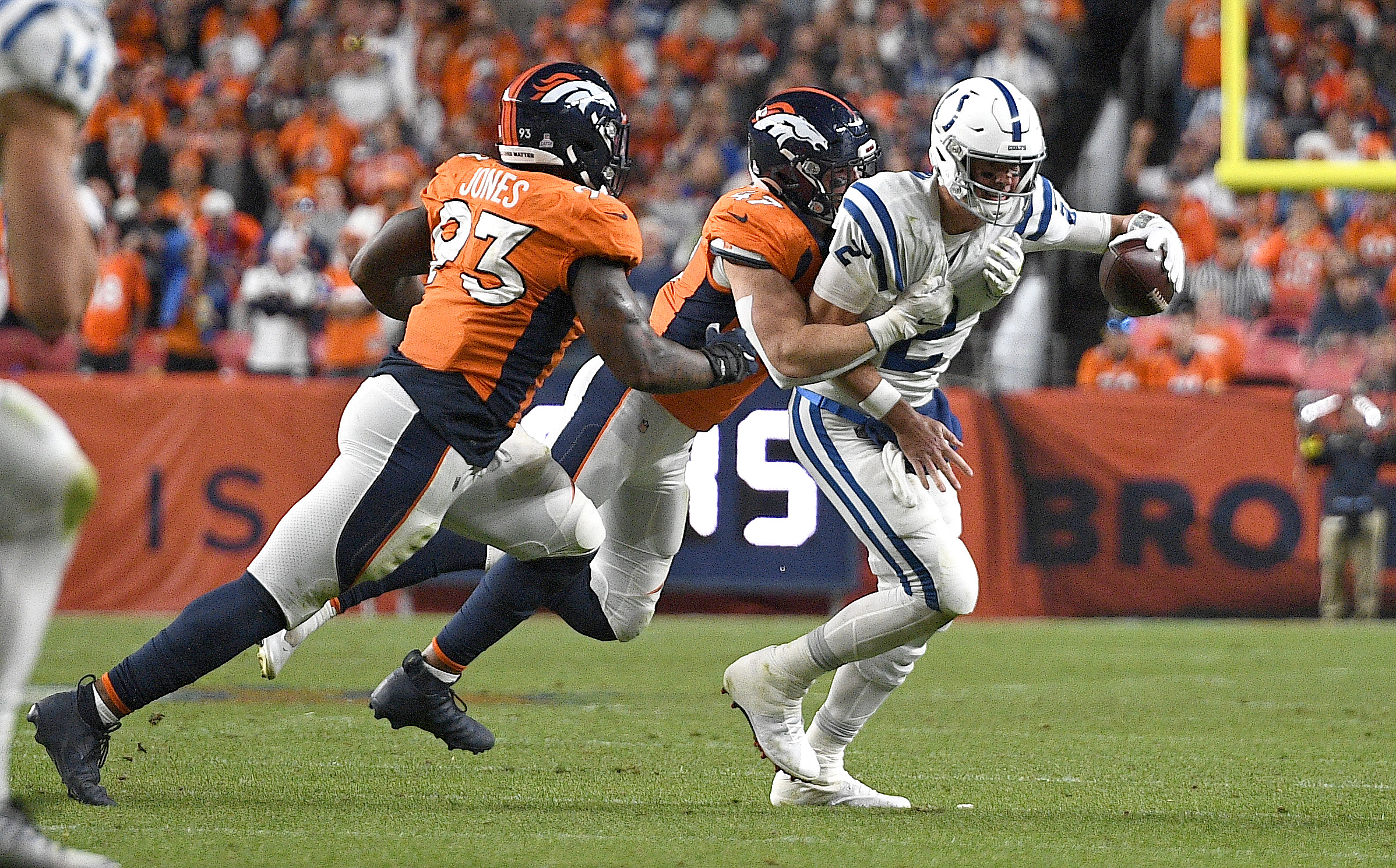 Quarterback Matt Ryan (R) of the Indianapolis Colts is sacked in the game against the Denver Broncos at Mile High in Denver, Colorado, October 6, 2022. /CFP