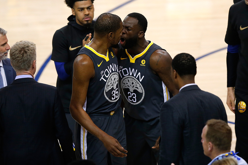 Draymond Green (#23) and Kevin Durant (#35) of the Golden State Warriors interact during Game 2 of the NBA Finals against the Cleveland Cavaliers at Oracle Arena in Oakland, California, June 3, 2018. /CFP