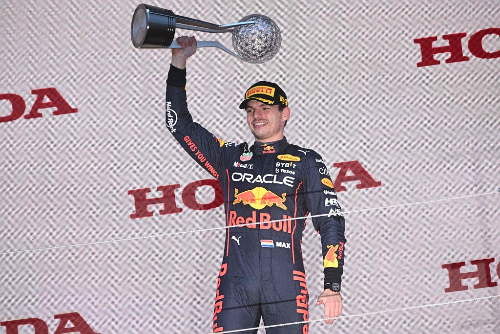 Red Bull Racing's Dutch driver Max Verstappen celebrates with the trophy following his victory at the F1 Grand Prix of Japan in Suzuka, Japan, October 9, 2022. /CFP 