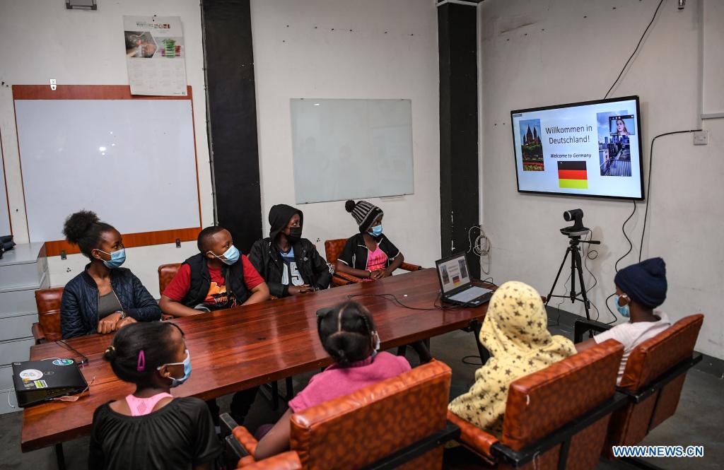 Levin Chama (2nd L, back), an 11-year-old boy, attends a class lectured by Laura Klein, a German college student, through video conferencing with his classmates at Konnect Hub in Githurai 44, a middle-to-low-income community on the outskirts of Nairobi, Kenya, July 24, 2021. /Xinhua
