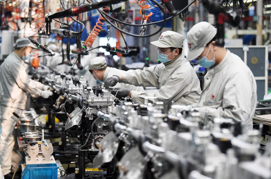 People work at a workshop of Harbin Dongan Automotive Engine Manufacturing Co., Ltd. in northeast China's Heilongjiang Province, February 25, 2021. /Xinhua