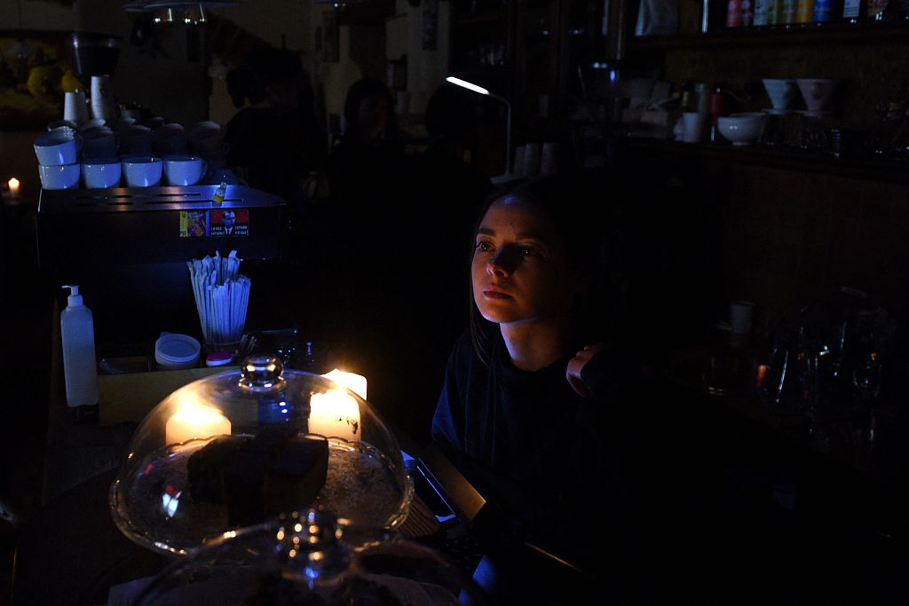 A barista works by candlelight in a cafe without electricity in the western Ukrainian city of Lviv, after three Russian missiles targeted energy infrastructure on October 11, 2022. /CFP
