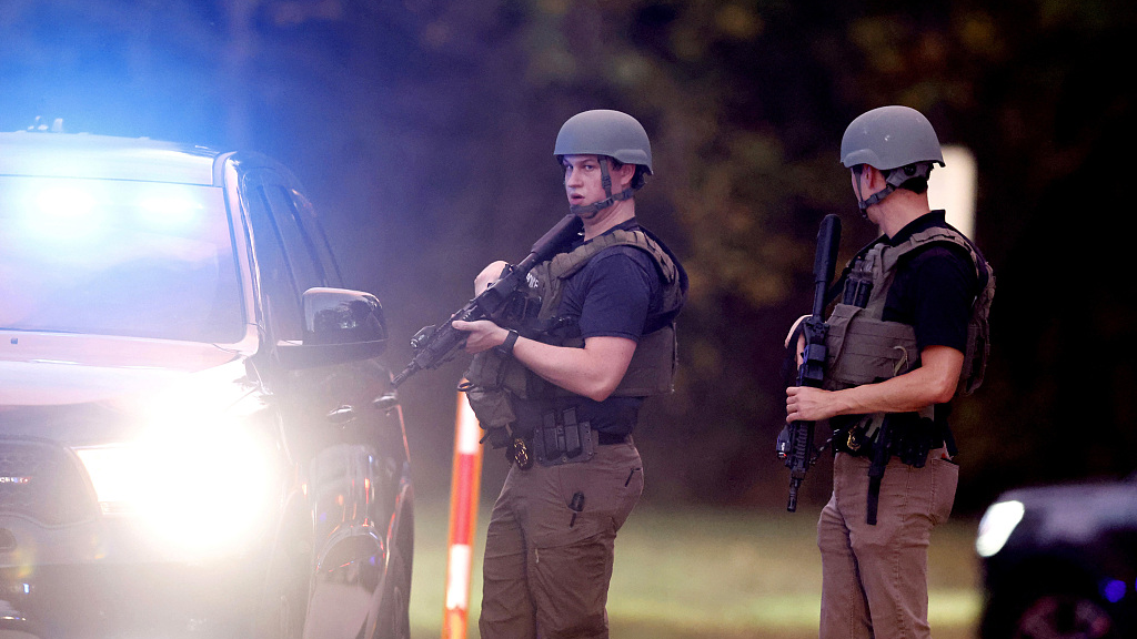 Law enforcement stand at the entrance to Neuse River Greenway Trail parking at Abington Lane following a shooting in Raleigh, North Carolina, U.S., October 13, 2022. /CFP