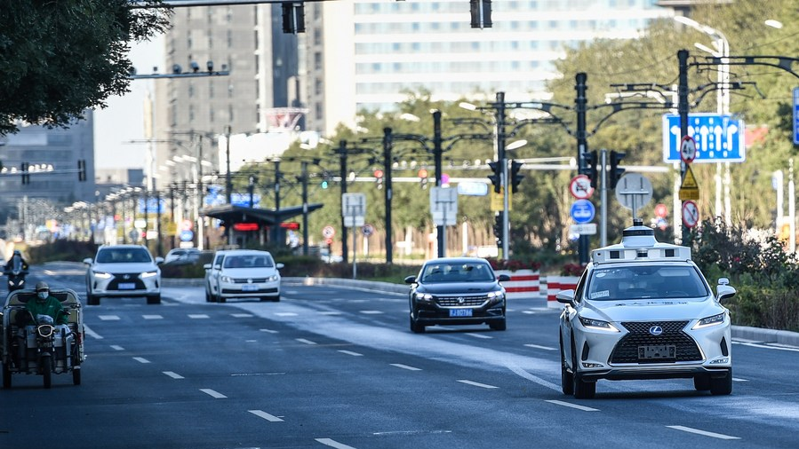 An autonomous vehicle (1st R) is undergoing a driverless test on a road in Yizhuang District, Beijing, China, October 19, 2021. /Xinhua