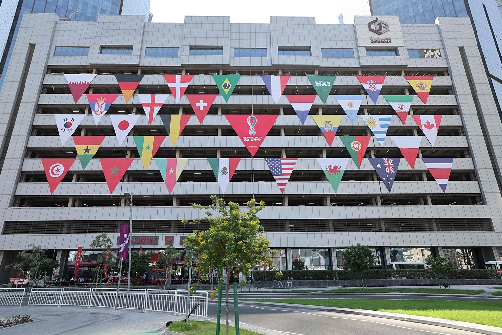A building decorated with the flags of the participating teams in the 2022 FIFA World Cup in Doha, Qatar, October 11, 2022. /CFP