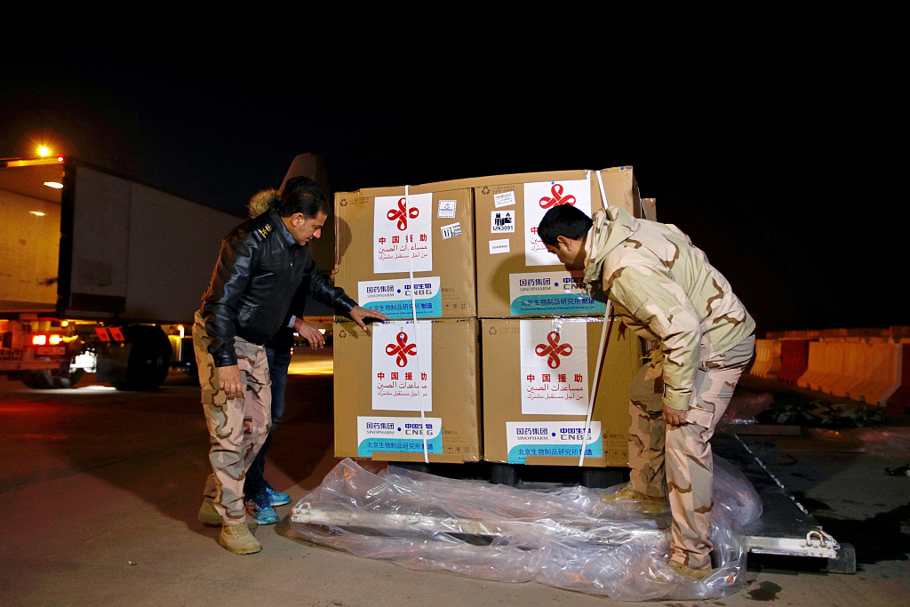 Unloading the first batch of doses of the Sinopharm vaccine against COVID-19 donated by China after it arrived at Baghdad International Airport, Baghdad, Iraq, March 2, 2021. /CFP