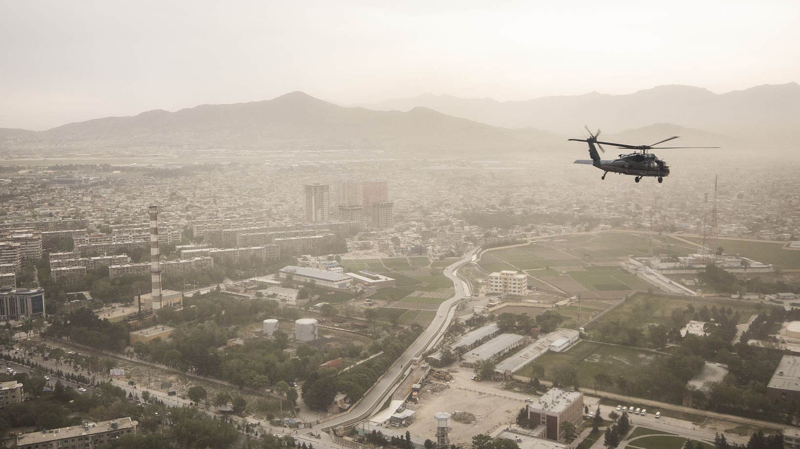 A Black Hawk helicopter of the U.S. Air Force is pictured in front of the cityscape in Kabul, Afghanistan, April 29, 2021. /Getty