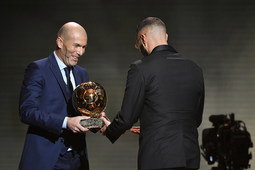 Karim Benzema (R) receives the award from Zinedine Zidane at the Theatre du Chatelet in Paris, France, October 17, 2022. /CFP 