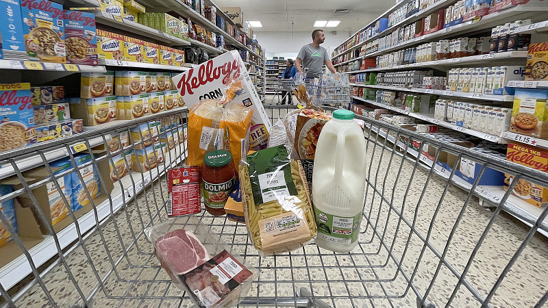 A small selection of essential items sits in a shopping trolley in a supermarket in Northwich, UK, July 06, 2022. /CFP