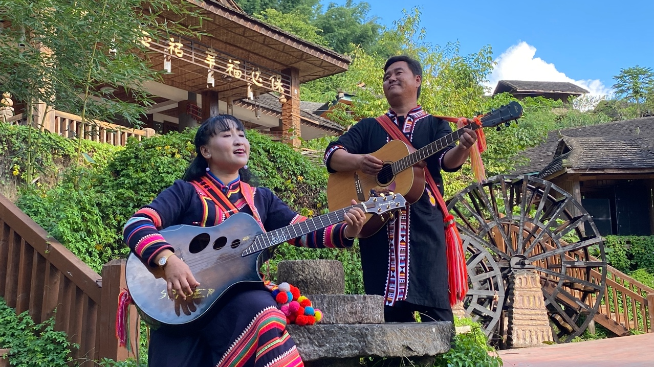 Li Naluo and her husband perform a song she writes in their village. Yang Jinghao/CGTN