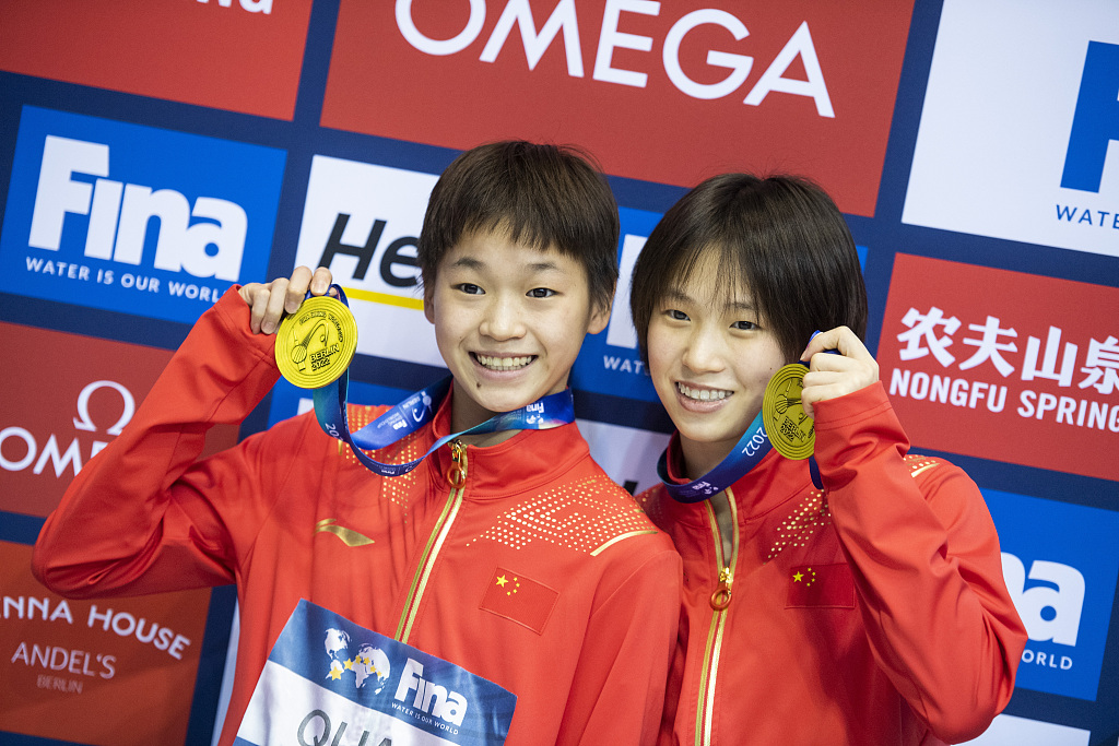 Quan Hongchan (L) and Chen Yuxi of China celebrate with their gold medals after the 10m synchronized final at the FINA Diving World Cup in Berlin, Germany, October 21, 2022. /CFP