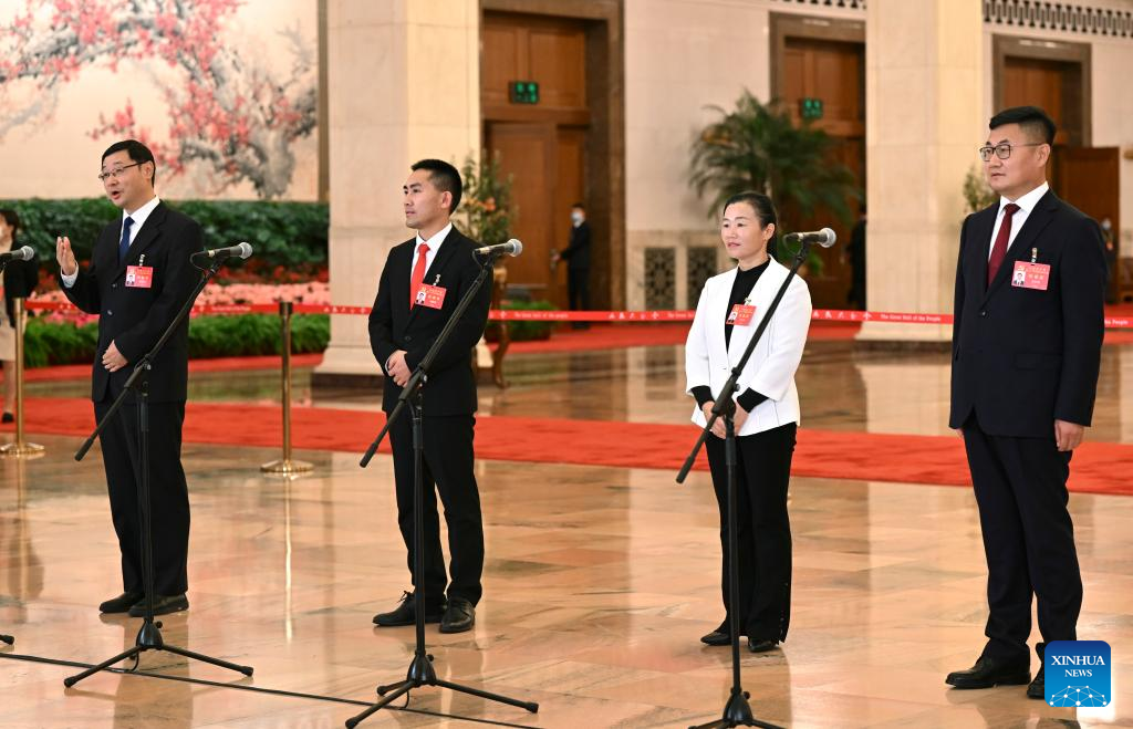 Delegates to the 20th National Congress of the CPC Yang Xinquan, Liu Xiuxiang, Shi Yulian and An Changming (from L to R) attend an interview session at the Great Hall of the People in Beijing, capital of China, October 22, 2022. /Xinhua