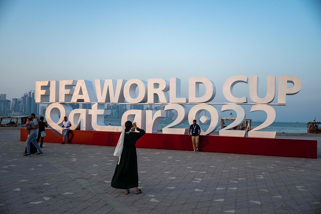 Visitors take photos with a FIFA World Cup sign in Doha, less than a month before the Qatar 2022 FIFA World Cup football tournament kicks off, October 23, 2022. /CFP