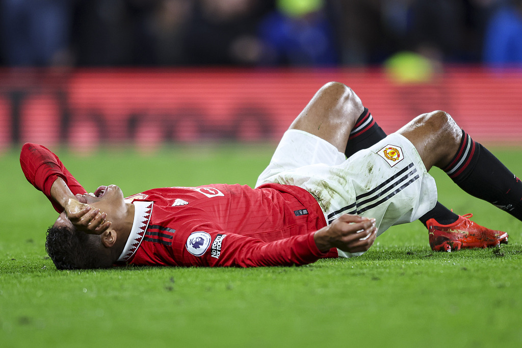 Raphael Varane of Manchester United lies on the field after suffering a hamstring injury during the Premier League game against Chelsea at Stamford Bridge in London, England, October 22, 2022. /CFP