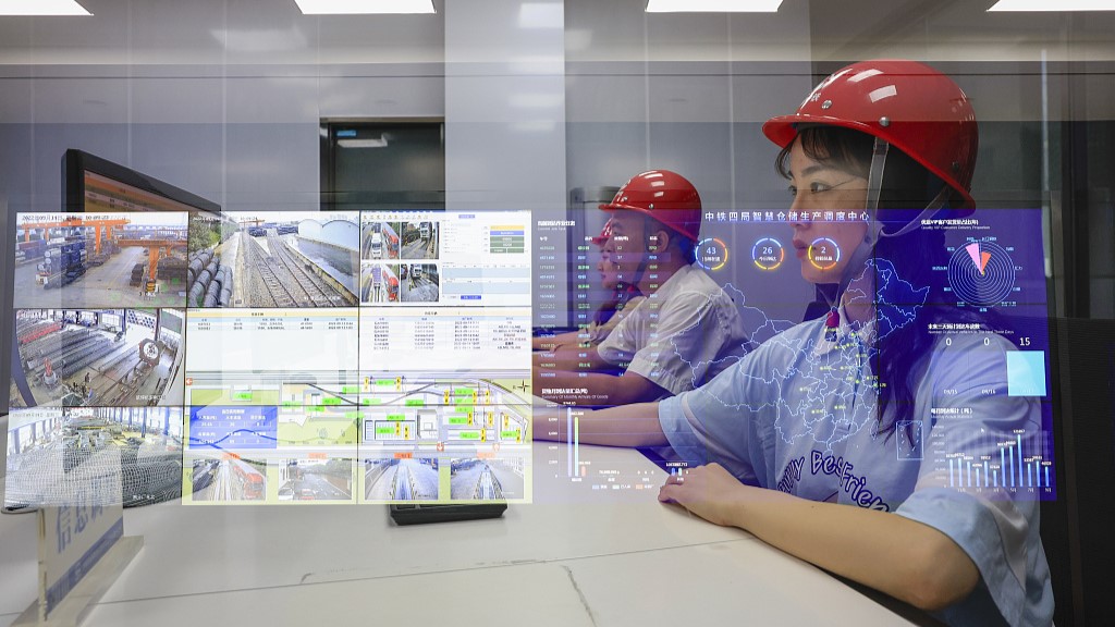 Technicians working on the smart storage platform at a subsidiary of the China Railway Group in east China's Anhui Province, September 14, 2022. /CFP