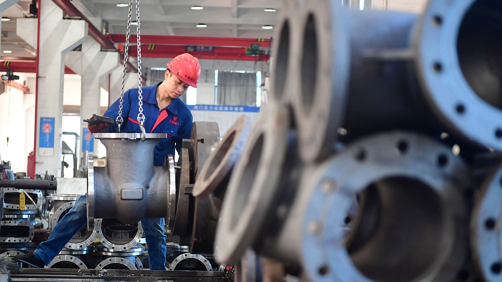 A worker operates on a production line in south China's Fujian Province, October 14, 2022. /CFP