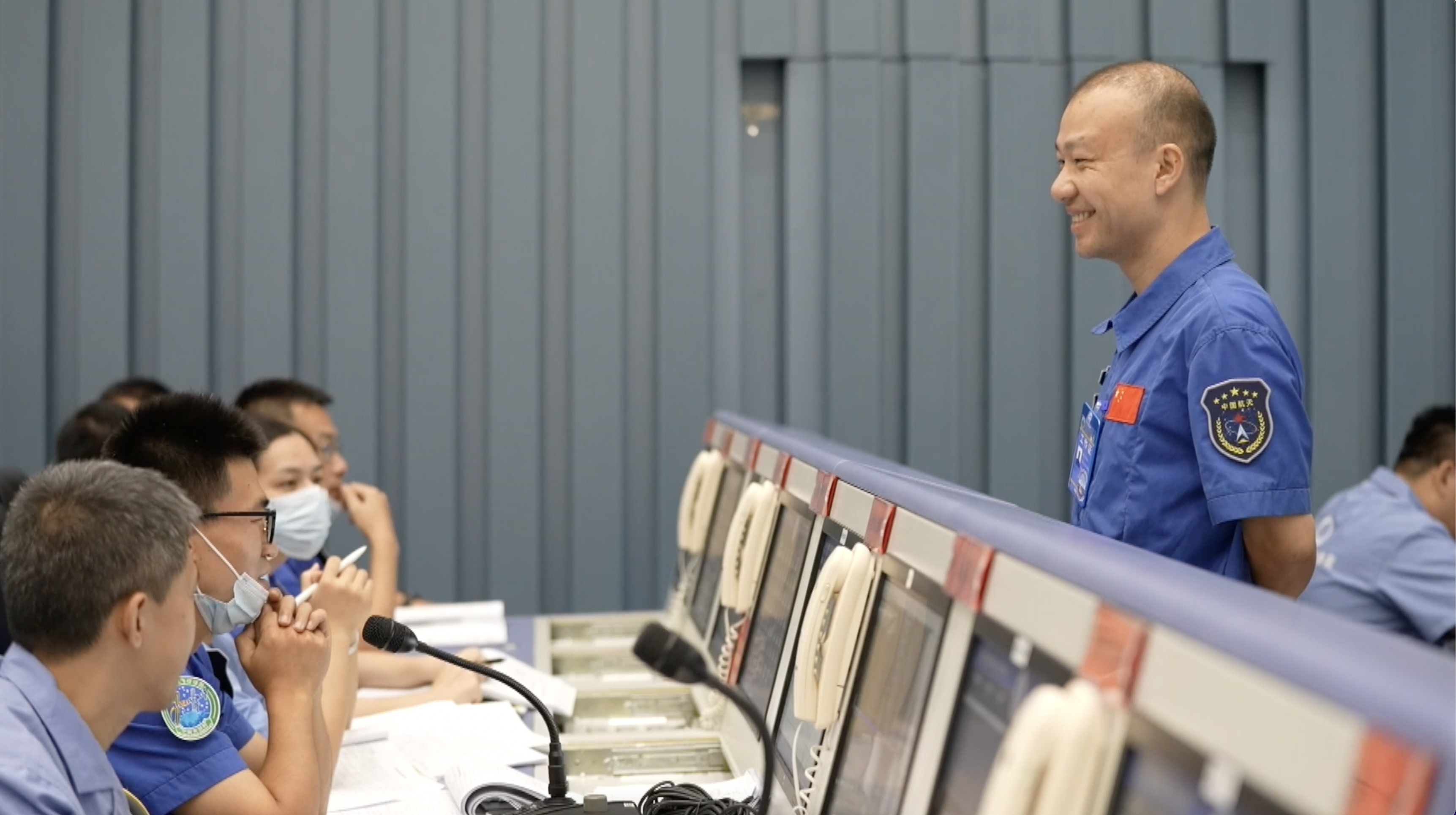 Liao Guorui talks with his teammates in a command center at the Wenchang Spacecraft Launch Site, south China's Hainan Province. /Wenchang Spacecraft Launch Site