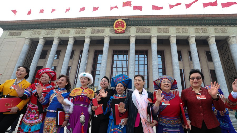 Deputies to the 13th NPC leave the Great Hall of the People after the closing meeting of the fourth session of the 13th NPC in Beijing, China, March 11, 2021. /Xinhua 