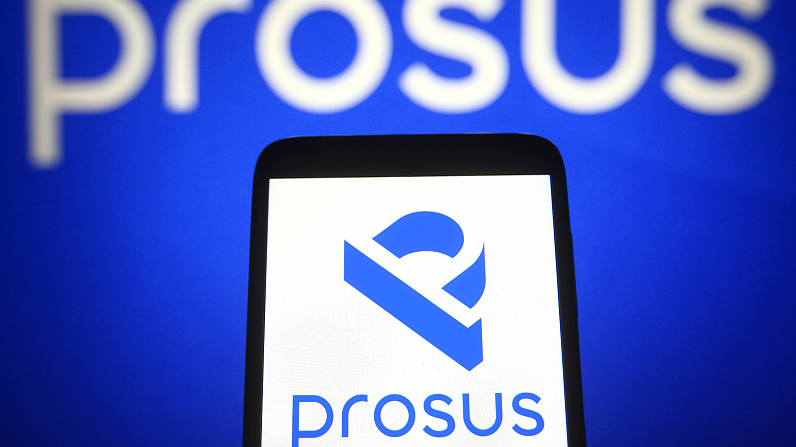 A Prosus logo is seen on a smartphone and a computer screen. /CFP 