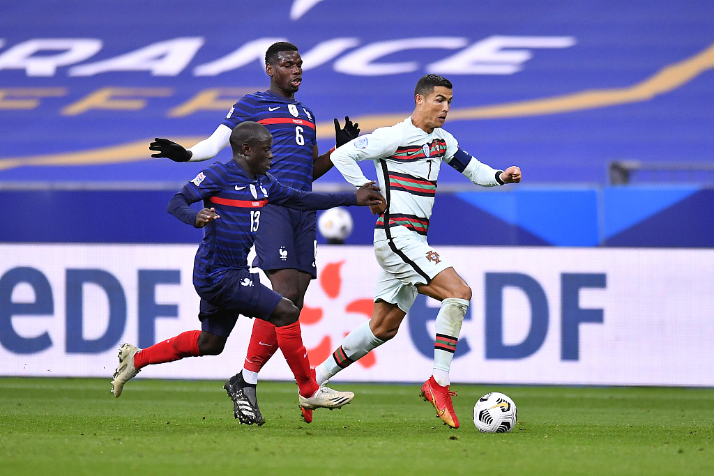 France midfielders N'Golo Kante (#13) and Paul Poga (#6) fight for the ball with Cristiano Ronaldo of Portugal during their Nations League group stage clash at Stade de France in Paris, France, October 11, 2020. /CFP