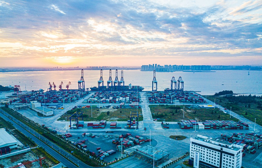 A view of the sunrise from Yangpu international container port at Yangpu economic development zone in south China's Hainan Province, December 5, 2021. /Xinhua