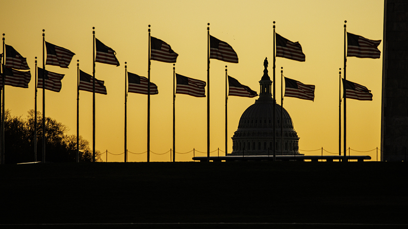 The U.S. Capitol dome was seen past the base of the Washington Monument as the sun rises in Washington, D.C.,  November 9, 2022. /CFP