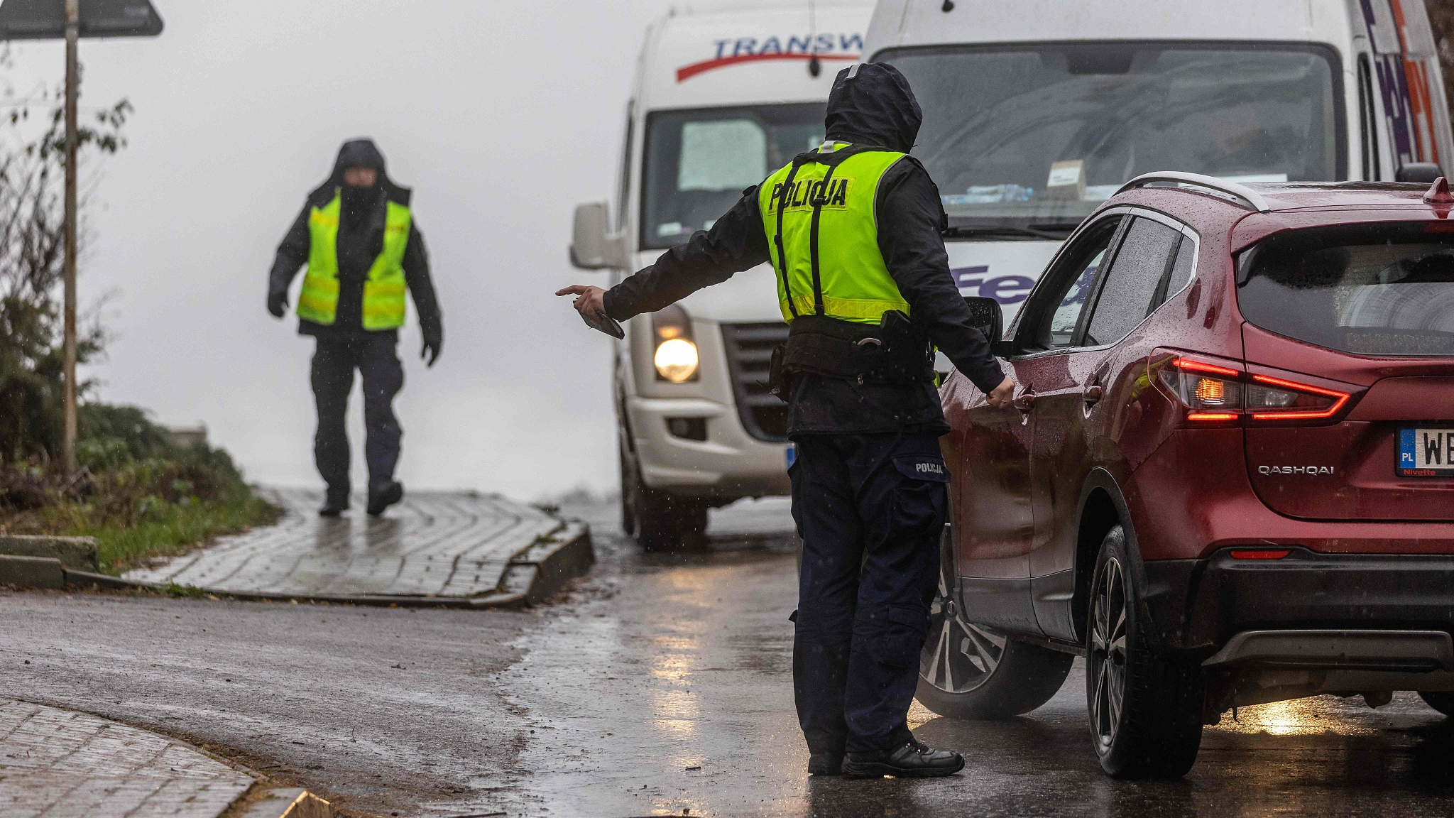 A police officer talks to a driver on the street near the site where a missile caused explosions in the village of Przewodow in Poland, November 16, 2022. /CFP