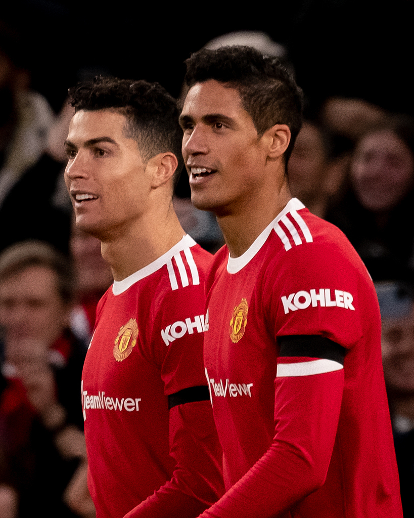 Cristiano Ronaldo (L) of Manchester United celebrates scoring his team's second goal with Raphael Varane during their Premier League clash with Tottenham Hotspur at Old Trafford in Manchester, England, March 12, 2022. /CFP
