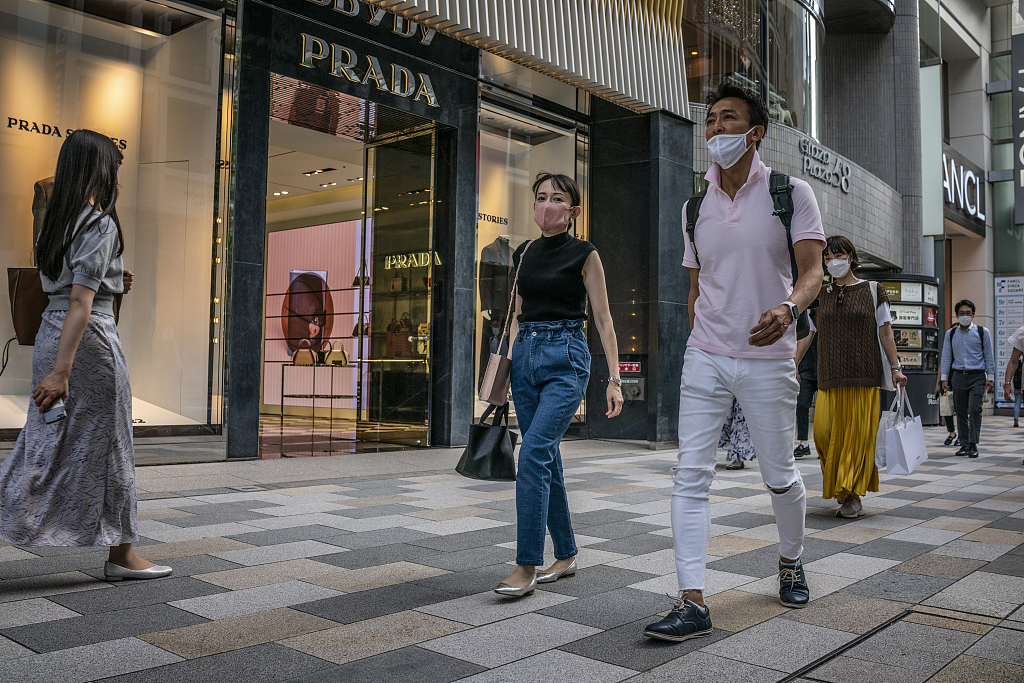 On September 16, 2022, Tokyo, Japan, pedestrians pass by a Prada store. The country's trade gap persists as a weak yen squeezes purchasing power. /CFP