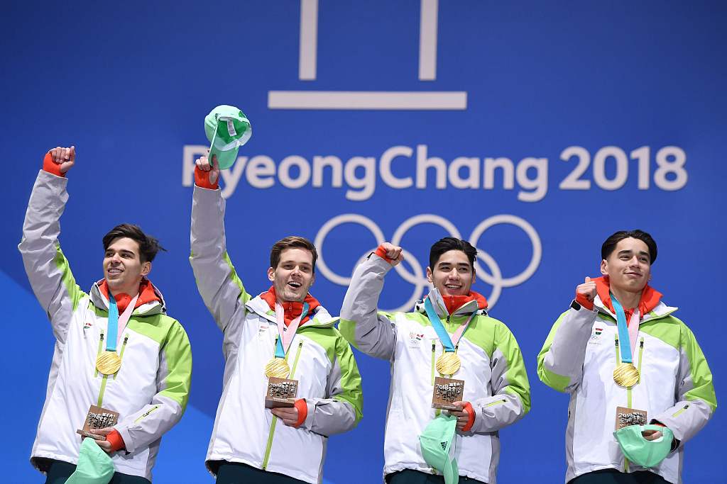 L-R: Csaba Burjan, Viktor Knoch, Shaolin Sandor Liu and Shaoang Liu of Hungary pose with the men's short track speed skating 5000-meter relay gold medals they win in the PyeongChang Winter Olympic Games in South Korea, February 23, 2018. /CFP
