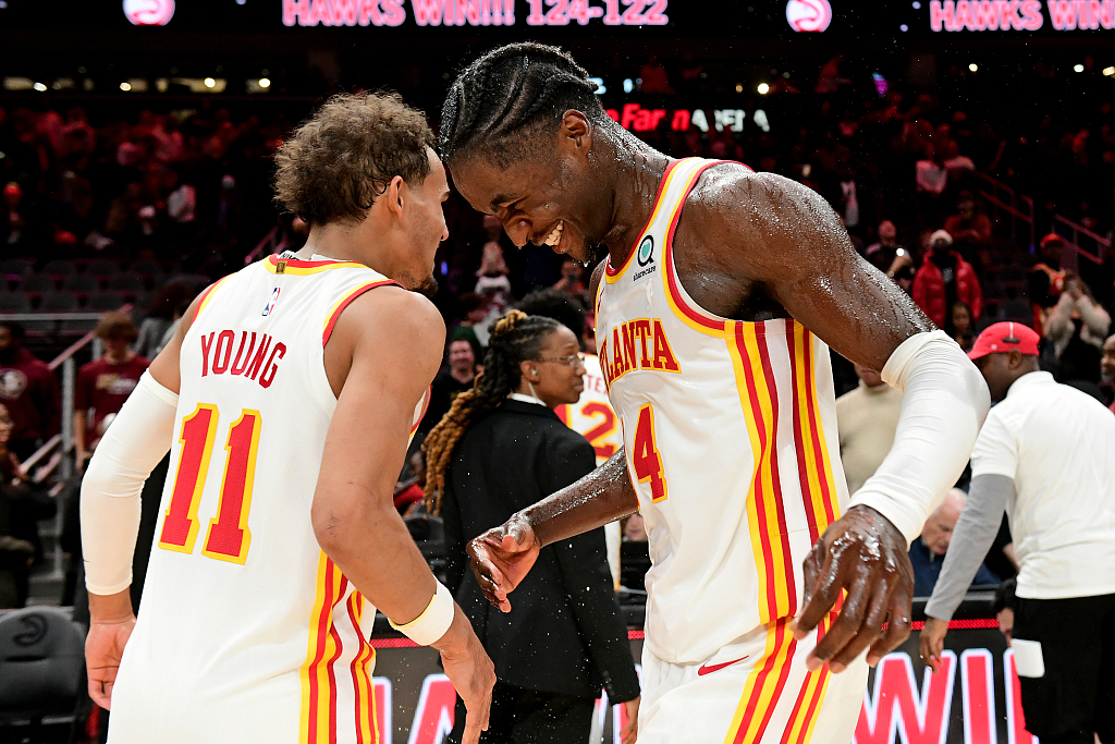 Trae Young (#11) and AJ Griffin of the Atlanta Hawks celebrate after the 124-122 win over the Toronto Raptors at State Farm Arena in Atlanta, Georgia, November 19, 2022. /CFP