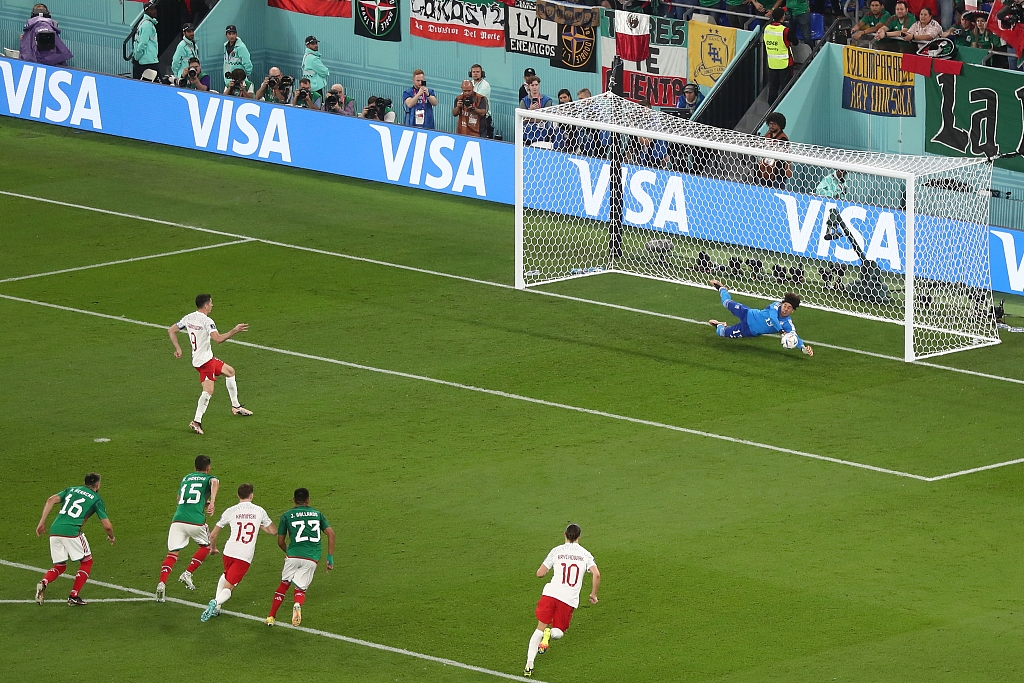 Goalkeeper Guillermo Ochoa of Mexico rejects the penalty kick shot by Robert Lewandowski of Poland in the FIFA World Cup game at Stadium 974 in Doha, Qatar, November 22, 2022. /CFP 