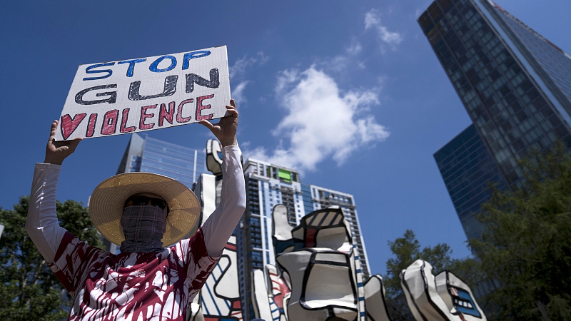 Gun control advocates hold signs during a protest at Discovery Green across from the National Rifle Association Annual Meeting at the George R. Brown Convention Center in Houston, Texas, the U.S., May 27, 2022. /CFP