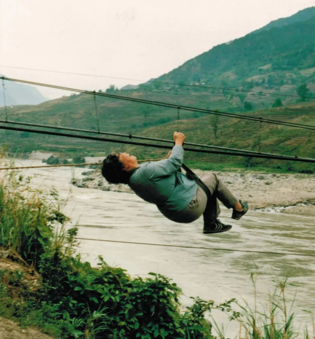 Li Huanying climbs a cable above a river in southwest China. /CMG