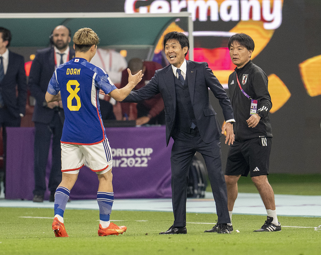 Hajime Moriyasu (R), manager of Japan, congratulates Ritsu Doan after Doan scored a goal in the FIFA World Cup game against Germany at Khalifa International Stadium in Doha, Qatar, November 23, 2022. /CFP