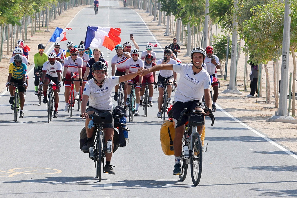 French duo Gabriel Martin (L) and Mehdi Balamissa cycle on their way to Doha, Qatar, November 17, 2022. /CFP